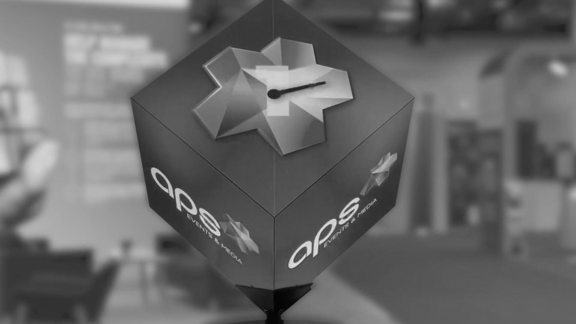A large LED cube with the aps logo presented on it.